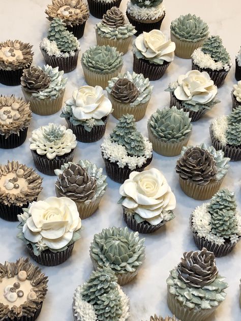 Beautiful mini cupcakes in Winter Woodland - Narnia theme for a baby shower, all hand designed with our signature buttercream - with trees, pine cones, flowers, lion and flowers Woodland Wedding Cake With Cupcakes, Baby It’s Cold Outside Shower Cupcakes, Woodland Forest Cupcakes, Arctic Fox Baby Shower, Winter Woodland Cupcakes, Pine Tree Cupcakes, Mountain Themed Cupcakes, Pine Cone Cupcakes, Woodland Cupcake Ideas