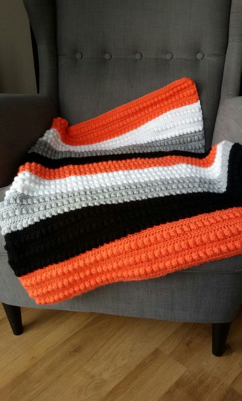 Bobble stitch, crochet, baby blanket in orange, black, grey and white Orange Crochet Blanket, Crochet Blanket Black, Halloween Crochet Blanket, Easy Crochet Baby Blanket Free Pattern, Loom Blanket, Bobble Stitch Crochet, Orange Bedding, Easy Crochet Baby Blanket, Irish Crochet Dress