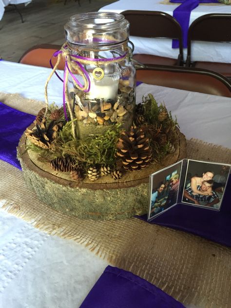 Wood chunk, mason jar with rocks and moss and pinecone centerpieces Lake Theme Centerpieces, Manly Centerpieces Table Decorations, Hunting Wedding Theme Centerpieces, Hunting Party Table Decor, Mason Jar Antler Centerpieces, Hunting Theme Table Centerpieces, Fishing Theme Centerpieces Mason Jars, Wild Game Dinner Decorations, Wild Game Dinner