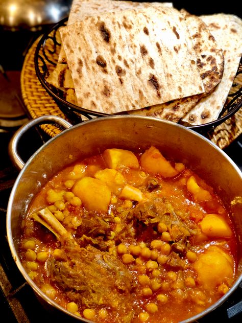 Iranian lamb shank stew with chickpeas, tomatoes, garlic, potatoes, and saffron. One pot comfort food for the cold months. Serve with flat bread (sangak pictured), raw onions, and torshi Persian Stew Recipes, Iranian Stew Recipes, Traditional Iranian Food, Lamb Shank Persian Recipe, Abgoosht Recipe, Iranian Dinner, Persian Potato Curry, Iranian Stew, Persian Lamb Stew