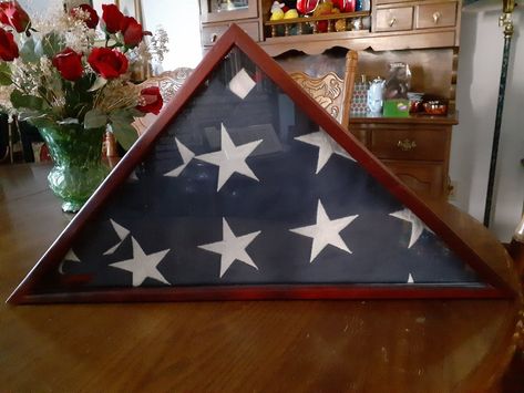 My Dad's folded flag in a case in my Dining Room. Because he had served he had the folding ceremony at his funeral. Until recently Today, Memorial Day is the perfect day to review the importance of each fold. Here they are for you if you are not familiar with them.  "WHY THE AMERICAN FLAG IS FOLDED 13 TIMES"  Have you ever wondered why the Flag of the United States of America is folded 13 times when it is lowered or when it is folded and handed to the next of kin at the burial of a veteran?  Her Folded Flag, Next Of Kin, Book Worm, The Flag, Folded Up, Usa Flag, States Of America, Memorial Day, United States Of America