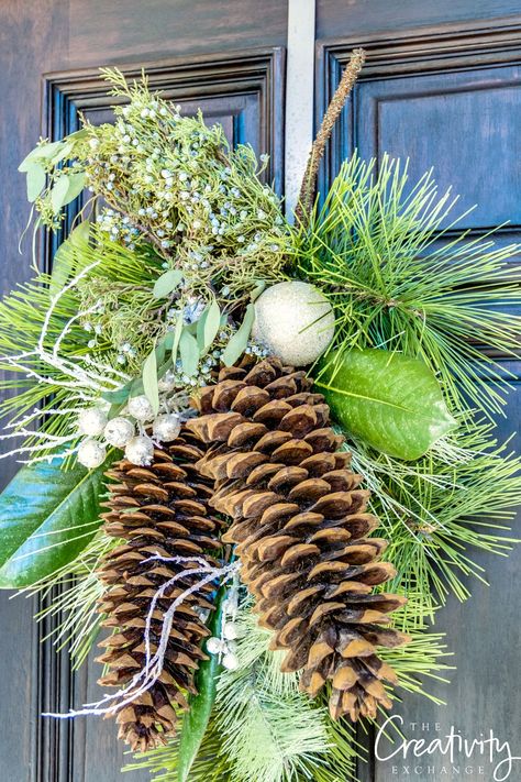 Christmas pine wreath swag with large sugar pine cones and fresh juniper berries. Sugar Pine Cone Crafts, Large Pine Cones Ideas, Large Pine Cone Crafts Ideas, Pine Boughs Decorations, Sugar Pine Cones Decorations, Extra Large Pinecones Ideas, Pine Cone Swags Diy, Large Pinecone Crafts Christmas, Pinecone Swag Christmas