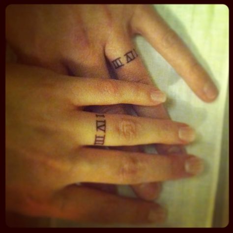 Love this placement idea.. so guna get both of us something small around our wedding fingers. gotta some serious ideas about what to get done to Bands Tattoo, Wedding Band Tattoo, Roman Tattoo, Ring Tattoo, Roman Numeral Tattoos, Wedding Ring Tattoo, Tattoo Wedding Rings, Ring Finger Tattoos, Ring Tattoos