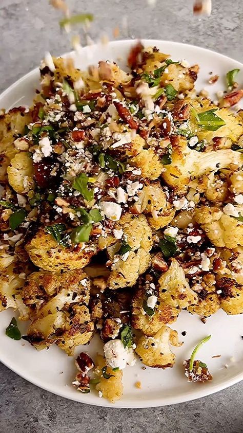 CAULIFLOWER BITES WITH PECAN-FETA-DATE CRUMBLE! Re-sharing this personal & fan-fave from last summer. It’s just perfect— I don’t say that lightly! • For the crumble: 1/2 cup raw pecans 5-6 dates 2 oz feta cheese Handful arugula 1/2 tsp salt 1/2 tsp pepper Zest of 1/2 lemon • For the cauliflower: 2 medium cauliflower, cut into florets 1 head garlic, top sliced off 2 tsp cumin 1 1/2 tsp dried oregano 1/2 tsp salt 1/2 tsp pepper 5 tbsp, plus more for garlic, olive or avocado oil • 1️⃣Preheat the Roasted Cauliflower With Pecans Feta And Dates, Roasted Cauliflower With Pecan Feta And Date Crumble, Date Crumble, Garlic In The Oven, Cauliflower Bake, Cauliflower Dishes, Holiday Side, Cauliflower Bites, Garlic Head