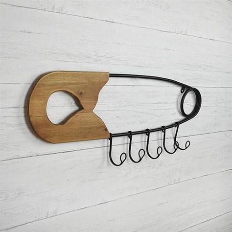 Safety Pin Wall Hanging with Hooks 28" L $ 24.95 Large safety pin wall hanging with five hooks. Great for sewing room, baby and kids rooms.  Size: 28" L x 10" H x 2.5" D Material: Metal, Wood Pin Wall, Laundy Room, Home Decor Gift Ideas, Rustic Accessories, Large Safety Pin, Clothing Store Interior, Decor Gift Ideas, Sewing Room Design, Store Design Boutique