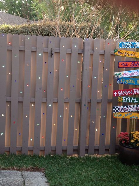 Added marbles to a plain fence. When the sun set it looks like stain glass... Just drilled holes, added glue around hole slide marble in. Very cute idea for small patio areas. Marble Fence Garden Art, Marble In Fence, Marbles In Fence Holes, Fence With Marbles In It, Marbled Fence, Stained Glass Fence, Marbles In Fence, Cute Fence, Marble Fence