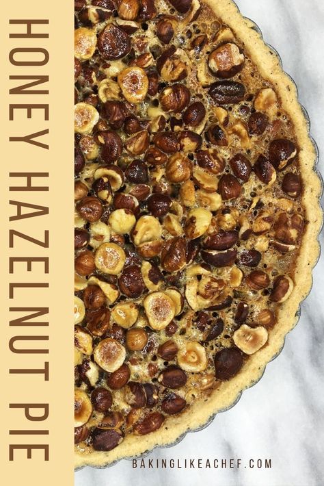 These all year round flavors of honey and toasted hazelnuts combine gorgeously in this easy Honey Hazelnut Pie. You will enjoy its hazelnut filling once you make it. If you are looking for a tasty homemade dessert to delight your dinner guests, this tart is the answer. #bakinglikeachef #pierecipes #hazelnutpie #hazelnuttart #piecrustrecipe #feedthecrowd #partyfoodideas | www.bakinglikeachef.com Hazelnut Puff Pastry, Dessert With Hazelnut, Easy Hazelnut Recipes, Hazelnut Pie Crust, Hazelnut Pie, Traditional Christmas Dessert Recipes, Hazelnut Tart, Hazelnut Filling, Traditional French Desserts