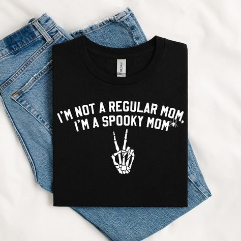 I’m not a regular mom, I’m a spooky mom ✌🏼💀🕷️🤍 The cutest T-shirt for all of my momma’s this Halloween season! Available on our Etsy now! ⭐️⭐️⭐️ Spooky Basket, Halloween Season, Cute Tshirts, Mom And Baby, The Cutest, Halloween, T Shirt, Quick Saves