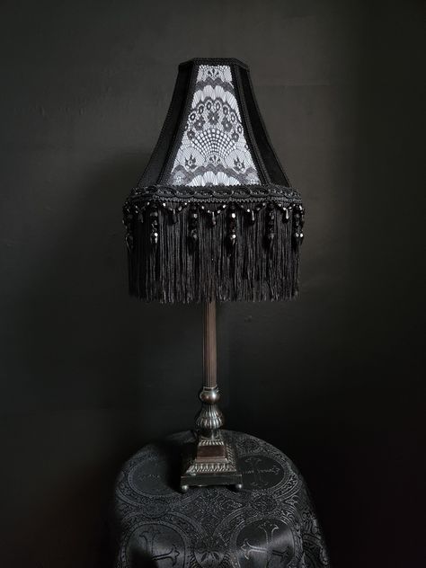 "Very beautiful handmade gothic victorian lampshade. Made with cotton, black lace, and white satin fabric. Along with black braid trim, and black fringe trim. The fringe is 6\" long. The lampshade is an UNO fitter, which has a larger ring and can be placed below the light bulb. *NEW DIMENSIONS Top Width - 4\" x 6\" Bottom Width - 9\" x 12\" Height - 10\" New dimensions are best described as rectangular rather than square.  Perfect for a medium and large lamp base. Inspired through gothic and victorian designs. *All other items in the image are not included" Black Victorian Bedroom, Gothic Lamps, Gothic Interior Design Victorian, Gothic Victorian, Victorian Gothic Bedroom, Victorian Bedroom Aesthetic, Goth Lampshade Diy, Witchy Lampshade, Goth Lamp