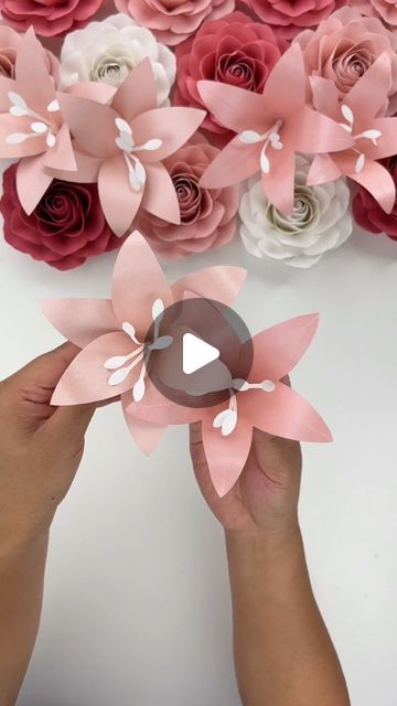 Hey, I’m Judy 👋🏻 Paper Flower Art + Tutorials on Instagram: "Here is the tutorial for my Mini Lily Template - there are two “designs” included mainly because I couldn’t pick one I liked most (and I figured anyone who wanted the template would like the two options).   The template uses very little paper per flower and I think these would be great to fill in gaps in paper flower bouquets or displays!   For paper, I used the two pink shimmer cardstock pack from @michaelsstores and I also used @bearlyarts glue for design 2. Using craft glue allows for more flexibility in the petal for shaping.   The Mini Lily Template is available in my Etsy shop, link in bio! I will also put a link in my stories and it will be saved to my “tutorial” highlights.  #paperflowers #lilies #cricut #cricutmade #te How To Make Lily Flower With Paper, Paper Lily Flower, Lily Template, Tiny Paper Flowers, Paper Flower Bouquet Tutorial, Lilium Flower, Paper Flower Bouquets, Paper Lily, Flower Petal Template