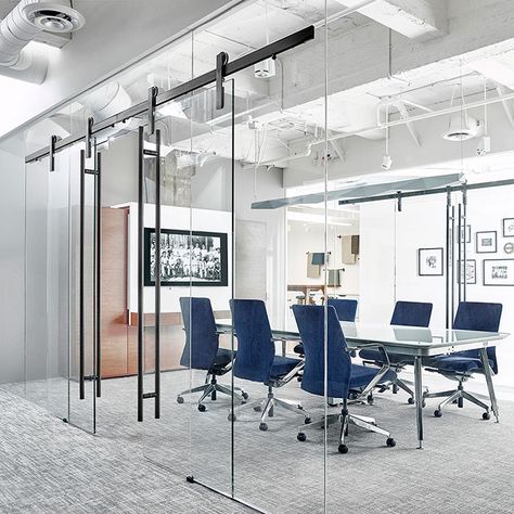 The Ragnar sliding door hardware system was designed with glass in mind. With a suite of adjustment features, it's perfect for curtain wall glass installations like this one from OFS. Office Meeting Room, Modern Barn Door, Office Meeting, Glass Walls, Office Snapshots, Modern Barn, Corporate Office, Barn Door Hardware, Office Interior Design