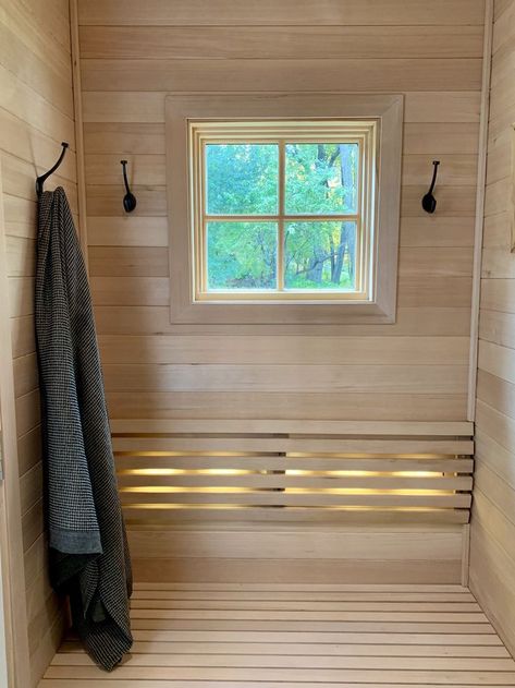 An attached changing room to the sauna is always a good idea. It serves as a place to undress/dress, sit down & cool off, take a water break, hang your towels, etc. The sauna interior of this outdoor sauna was carried over into the changing room. Beautiful! #finnleo #finnleosauna #sauna #saunachangingroom #saunadressingroom #outdoorsauna #saunadesign #dressingroom #changingroom #backyardsauna Sauna Changing Room, Sauna Project, Sauna Interior, Room With Window, Sauna Accessories, Sauna Design, Outdoor Sauna, Changing Room, Hanging Towels