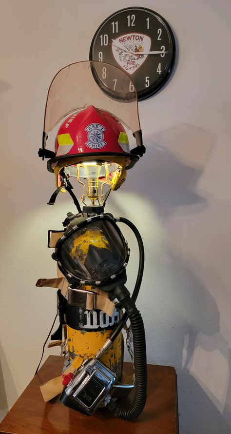 Firehouse Decor, Firefighter Helmet Display, Firefighter Home Decor Ideas, Fire Department Ornaments Diy, Firefighter Lamp, Fire Hose Projects, Firefighter Man Cave, Fire Hose Crafts, Fire Department Decor