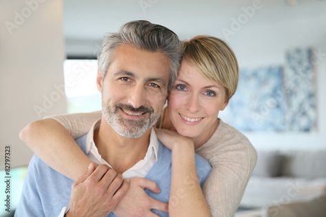 Stock Image: Smiling middle-aged couple standing in brand new home Middle Aged Couple Photography, Middle Aged Couple Photography Poses, Older Couple Poses, Older Couple Photography, Couple At Home, Autumn Family Photography, Anniversary Photography, Brand New Home, Wedding Photos Poses