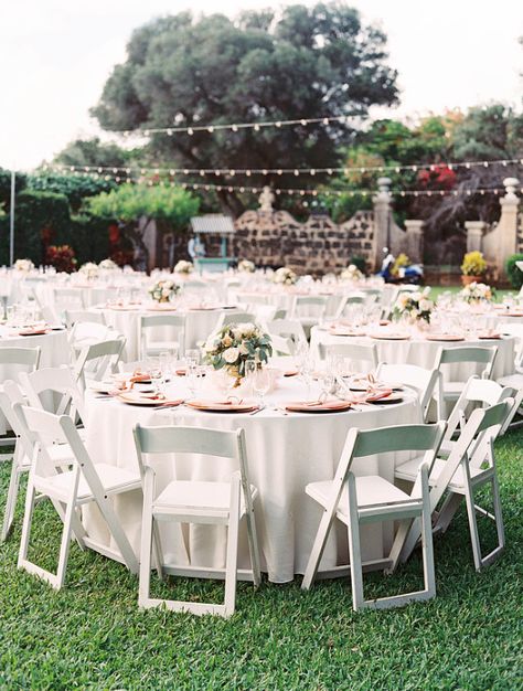 Guest tables with White Resin Chairs (66" round tables with Ivory linens and Peach napkins) White Table White Chairs Wedding, Wedding Table White Chairs, White Table And Chairs Wedding, Ivory Table Linens Wedding, White Resin Chairs Wedding, Wedding Ceremony White Chairs, White Chairs Wedding, Yucatan Wedding, Quinceañera Decorations