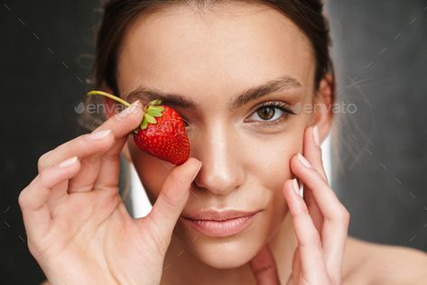 Image of beautiful caucasian young shirtless woman holding strawberry by vadymvdrobot. Image of beautiful caucasian young brunette shirtless woman holding strawberry isolated over gray background #Sponsored #young, #shirtless, #woman, #Image Strawberry Reference, Holding Strawberry, Modern Graphic Design, Gray Background, Female Portrait, Graphic Design Art