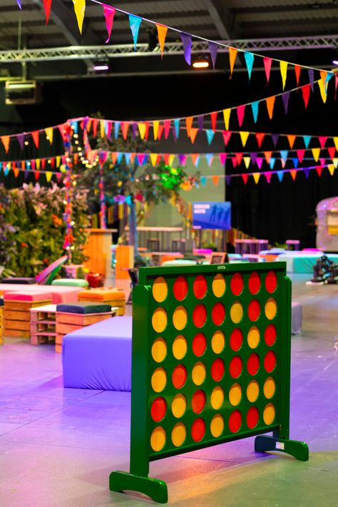 Get ready to level up your event with a playful twist! Our giant Connect Four is the perfect icebreaker for guests of all ages. Set against a backdrop of bunting flags and create the perfect festival event indoors! Check out our website for more information. Festival Event Decor, Festival Event Design, Indoor Festival, Indoor Festival Themed Party, Festival Set Up, School Festival, Festival Party Theme, Festival Celebration Sets With Intricate Design, Festival Themed Party Decorations