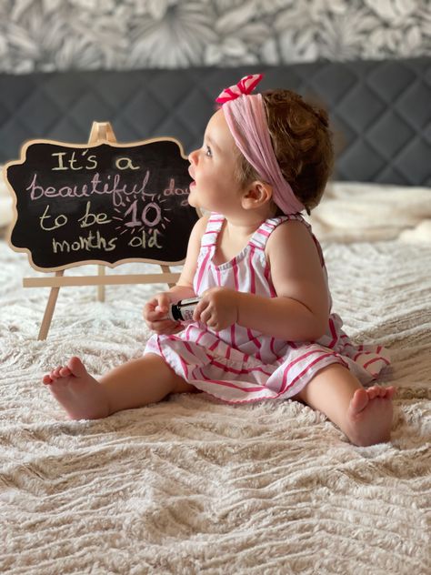 Baby girl with pink outfit sitting on bed with a board says “it’s a beautiful day to be 10 months old” 9 Months Old Baby Photoshoot, Baby Photoshoot Ideas 10 Months, 10 Month Old Milestones Photo Ideas, 10month Baby Photoshoot, 10 Month Baby Photoshoot Photo Ideas, 10 Month Milestones Baby, 10 Month Old Photoshoot, 10 Months Old Baby Photoshoot, 10 Month Old Baby Photo Ideas