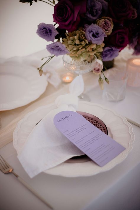 Lavender purple arched wedding menu, featuring the guest names at the top. The guest name at the top of the menu as a place card is such a great idea! Elegant fonts and minimalist look for your beautifu wedding, created by A Tactile Perception. Image by Fotogenica. Purple Wedding Stationary, Lilac Place Setting Wedding, Purple Wedding Table Decorations, Colorful Wedding Menu Design, Lilac Wedding Stationery, Colourful Weddings, Purple Wedding Tables, Lilac Wedding Invitations, Tangerine Wedding