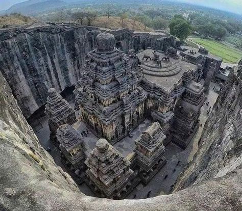 Ellora in the Aurangabad district of Maharashtra is one of the largest rock-cut Hindu temple cave complexes in the world. A UNESCO World Heritage Site, it is home to over 100 caves of which 34 are open to the public.All the caves have been excavated from the basalt cliffs in the Charanandri Hills. Known as the Ellora Caves collectively, caves number 1 to 12 are Buddhist caves, 13 to 29 are Hindu caves and Jain caves are number 30 to 34. The Hindu and Buddhist caves at Ellora were built during th Mountain Sculpture, Ancient Indian Architecture, Temple Design For Home, Mysterious Places, Indian Architecture, Ancient India, Hindu Temple, Ancient Temples, Vacation Places