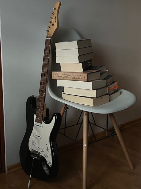 an electric vintage guitar, leaning against a chair, and a mountain of books on the chair, a small library Guitar And Books Aesthetic, Guitar Aesthetic, Guitar Books, Slide Guitar, Vision Board Photos, Books Bookshelf, Retro Gadgets, Aesthetic Books, Guitar Collection