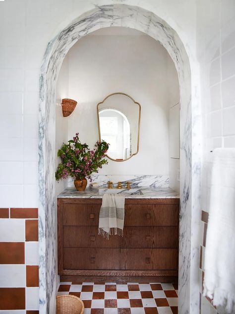 Beneath this bathroom arch? A dreamy vanity with marble countertops. Find more organic modern design ideas inside this renovated home. Ikea Vanity, Spanish Style Architecture, Sarah Sherman Samuel, Spanish Villa, Stucco Homes, Aesthetic Bathroom, Spanish Style Home, Iron Railing, Spanish House