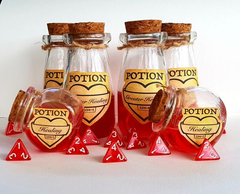 New D&D healing potion props available now!  There is the standard healing potion (2d4+2) and the greater healing (4d4+4). Both include the dice, plus the stats are on the label, so no more flicking through the players handbook! Dnd Props, Dm Dnd, Dnd Room, Dnd Party, Poison Bottles, Dnd Diy, Healing Potion, Dnd Accessories, Dnd Crafts