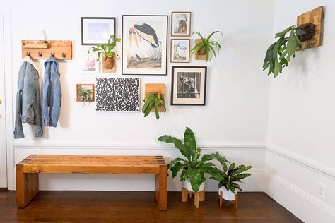 This minimalist space still has plenty of personality. The entryway has a stunning gallery wall with tons of smart gallery wall ideas and inspiration. We love the plants hanging from the wall and the natural wood elements throughout. Palladian Window, Gallery Wall Ideas, Plants Hanging, Minimalist Space, Wall Hanging Diy, Minimal Home, Macrame Ideas, Decor Accents, Wall Ideas