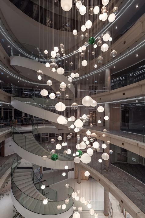 An interactive lighting installation that sparkles and surprises. 🌟 This bespoke Preciosa Lighting installation consist of 226 hand-blown crystal spheres representing the bank�’s branches. ✨
We used modern technologies as a welcome and a thank you to employees and customers. 

🤍 What do you think about the atrium of Credit Agricole’s regional headquarters in Clermont-Ferrand, France? Atrium Lighting Design, Atrium Chandelier, Atrium Lighting, Hotel Penthouse, Interactive Lighting, Atrium Design, Orb Light, Lighting Installation, Large Pendant Lighting