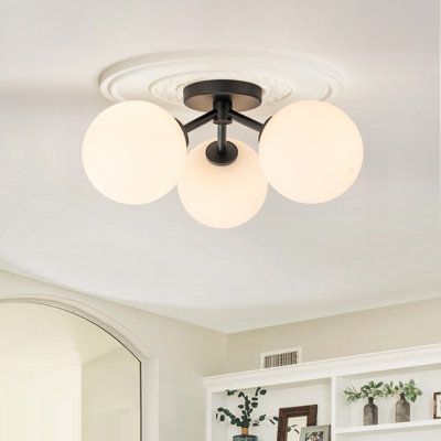 This contemporary glass Sputnik ceiling light possesses 3 white glass globe shades with a stylish gold and black finish available. With a special lamp frame, light is spread more wonderfully. It is perfect for any of your areas like the dining room, kitchen island, foyer, living room, entryway, hallway, or stairwell. | Mercer41 Pritee Glass Semi Flush Mount gray/White/Black 18.2 x 18.2 in | C100619364_1066847230 | Wayfair Canada Black Kitchen Light Fixtures Flush Mount, Studio Mcgee Entryway, Mcgee Entryway, Foyer Living Room, Black Lights, Lamp Frame, Living Room Light Fixtures, Black Light Fixture, Entryway Lighting