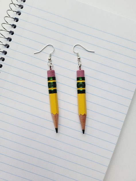 "Ticonderoga Pencil Earrings Get ready for Back to School with these pencil earrings! Made from the \"World's Best Pencil\" ✏️ Perfect gift for Teachers and Artists! :: DETAILS :: - Made with real pencils - Size is approximately 3.25 inches - Hypoallergenic ear wires If you like this item, you might also like >> Crayon Earrings : https://www.etsy.com/listing/800576416/crayon-earrings-l-crayola-earrings-l Colored Pencil Earrings : https://www.etsy.com/listing/1215461587/colored-pencil-dangle-earr Pencil Clay Earrings, School Spirit Jewelry, Teacher Earrings Diy, Back To School Jewelry, Ticonderoga Pencil, Gifts For Artist, Crayon Earrings, School Earrings, Pencil Earrings