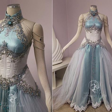 Our customer sent us an image of Tyrande Whisperwind from World of Warcraft to use as inspiration in her gown design. I wanted to give the feeling that her gown was woven from moonlight! We used a two-tone crinkle barbie organza over a teal satin to give that moonlight glow. Her corset and peplums are made from a iridescent tiny scale patterned brocade. We stacked silver vine lace over a floral metallic lace to trim her neckline and corset. For that midnight glimmer, crystals and pearls twin... Firefly Path, Gaun Abad Pertengahan, Elf Dress, Silver Fairy, Fest Outfits, Gaun Fashion, 파티 드레스, Fantasy Dresses, White Corset