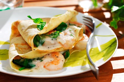 Crêpes with Shrimp, Spinach and Herb Filling | Recipe by: Ellie Krieger MS RD | These scrumptious, savory crêpes are easy to make and will bring an elegant flair to your special brunch menu. Using canola oil in the crêpe batter rather than butter and replacing some of the white flour with whole-grain flour makes the crêpes healthier without sacrificing their rich, decadent taste. Shrimp Spinach, Crepes And Waffles, Savory Crepes, Crepe Recipes, Filling Recipes, Seafood Dishes, Fish And Seafood, Burritos, Healthy Cooking