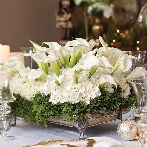 The holidays are the time to really kick your table centerpieces up a notch. When you’re serving elegant holiday dinners, it just feels appropriate to have an equally elegant floral arrangement to go along with it. Paula loves making large-scale arrangements, from a grand Lowcountry centerpiece to a low winter-white arrangement. The best part about Christmas Flower Arrangements, Christmas Table Centerpieces, Christmas Floral Arrangements, Christmas Arrangements, Christmas Tablescapes, Christmas Flowers, Deco Floral, Round Decor, Elegant Christmas