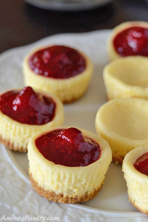 Mini raspberry cheesecake are the perfect size dessert for parties or for those days when you crave something sweet. Eat them plain or drizzled with this amazing homemade raspberry glaze. #tea #party #ideas #kids #cheesecake |amiraspantry.com No Bake Raspberry Cheesecake Bites, Raspberry Mini Cheesecakes, Mini Raspberry Cheesecake Recipes, Mini Raspberry Cheesecake, Raspberry Cheesecakes, Raspberry Cheesecake Bites, Cheesecake Cupcakes Recipe, Raspberry Glaze, Party Ideas Kids