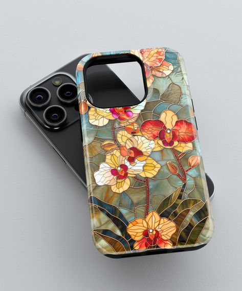 Elevate your phone's style with our handcrafted 'Stained Glass Orchid' phone case, compatible with iPhone, Galaxy, and Pixel models. This exquisite accessory boasts a timeless floral pattern inspired by the elegance of stained glass art. Each orchid bloom and leaf is meticulously detailed to capture the essence of a classic stained glass window, bringing an air of sophistication to your device. **Key Features * 100% polycarbonate (shell), 100% TPU (lining) * Dual layer case for extra durability and protection * Available with a glossy finish * Precisely aligned port openings * Wireless charging compatible (non magsafe) Please note, colors may appear slightly different in person due to varying screen displays. The design was created to give the illusion of the case being 3D. This design wil Orchid Phone Case, Stained Glass Phone Case, Stained Glass Orchid, I Phone Cases, Iphone 11 Phone Cases, Aesthetic Iphone Cases, Phone Case Ideas, Phone Case Floral, Floral Iphone Case