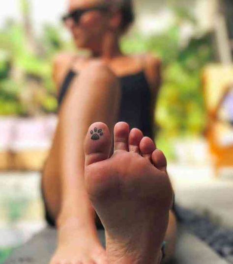 40 Best Hidden Tattoo Ideas | YourTango Tatoo Dog, Toe Tattoos, Pawprint Tattoo, Hidden Tattoos, Hamsa Tattoo, Paw Tattoo, Mother Tattoos, Disney Tattoo, Geniale Tattoos