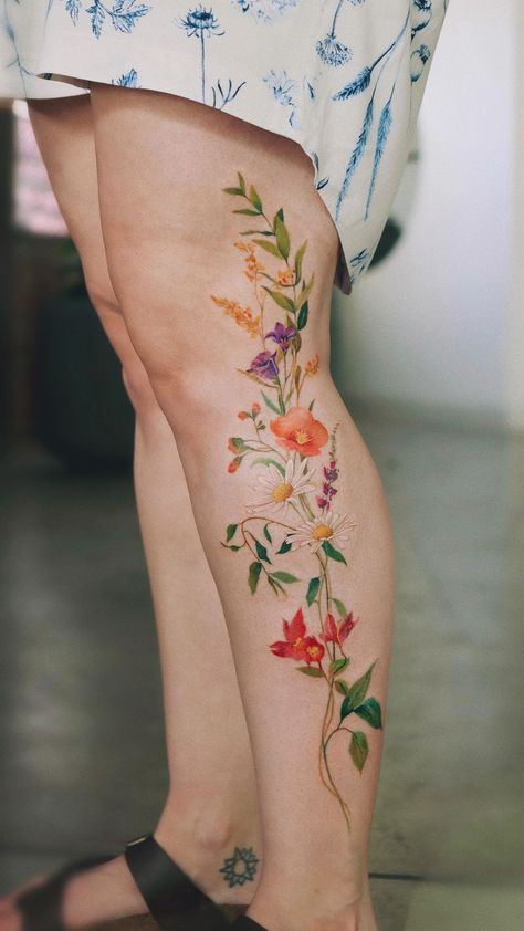 30 Best Female Tattoo Ideas to Inspire You Wrapping Flower Tattoo, Plant Tattoos For Women Leg, Fineline Nature Tattoo, Tattoo Ideas For Legs For Women, Flower Woman Tattoo Design, Wild Flower Leg Tattoos Women, Leg Tattoo Female, Flora Leg Tattoo, Flower Garden Leg Tattoo