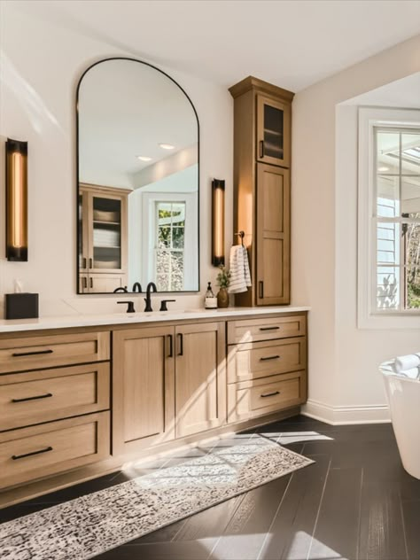 Go to the link to see more of this stunning primary bathroom remodel. This custom vanity was built for beauty and tons of storage. Long arched mirrors and linear sconces. Black matte plumbing fixtures. Open glass doors on the top cabinets to display decor. Modern Scandinavian style. Black wood herringbone tile floors. Oak Vanity Bathroom, Modern Vanity Lights, White Oak Vanity, Oak Vanity, Oak Bathroom, Beautiful Sunday, Quarter Sawn White Oak, Wood Bathroom Vanity, Come Soon