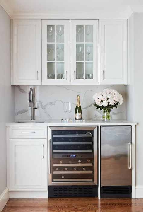 Beautiful white wet bar features glass front cabinets mounted between white raised panel cabinets fitted above a square sink with a satin nickel gooseneck faucet. Kitchen Wet Bar, Home Wet Bar, Basement Bar Designs, Small Basements, Cocktails Bar, Home Bar Designs, Kitchen Inspiration Design, Counter Tops, Wet Bar