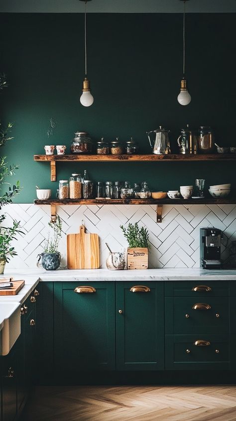 Dark green kitchen with white marble tiles, vintage decor, chevron backsplash, wooden shelves, and golden accents. Green Teal Kitchen Cabinets, Kitchen Ideas Emerald Green, Kitchen Backsplash Sage Cabinets, Two Tone Kitchen Cabinets Dark Green, Dark Green Cabinets White Countertops, Matte Green Kitchen Cabinets, Green Cabinets Copper Hardware, Dark Green Aesthetic Kitchen, Dark Green Kitchen Inspiration