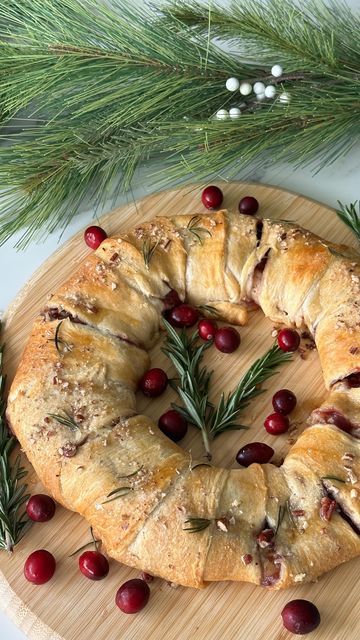 Audrey Lillian on Instagram: "Cranberry Brie Pull Apart Wreath   I’ve seen this recipe so many times and finally gave it a try! I can say it’s 100% worth the hype and such an easy yet beautiful appetizer to make for the holidays. Give it a try, you’ll love it!   Ingredients: -2 rolls @pillsbury crescent dough  -1/2 cup cranberry sauce  -1/2 wheel of Brie  -1/4 cup pecans   Optional toppings: -butter  -coarse sugar  -pecans  -rosemary sprigs  -fresh cranberries  -honey   Instructions: 1. Preheat oven to 375F. Unroll and cut apart crescent dough. Place a small plate or bowl in the center of some parchment paper or a lined baking sheet and layer the dough around it to create a wreath shape.  2. Spread your cranberry sauce onto the dough. Top with Brie slices, add more cranberry sauce and spri Brie Wreath Appetizer Puff Pastry, Cranberry And Brie Crescent Ring, Baked Brie Pillsbury Crescent Rolls, Brie Bread Pull Apart, Brie Wreath Appetizer, Cranberry Brie Wreath, Pull Apart Wreath, Cranberry Brie Pull Apart Bread, Cranberry Brie Puff Pastry