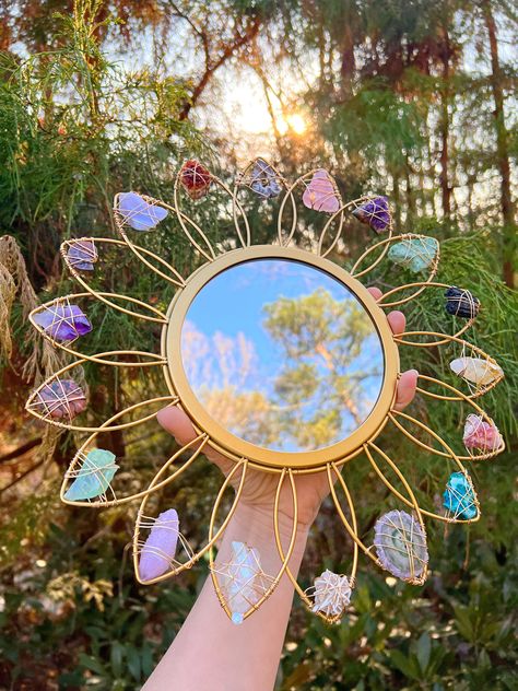 "This is a preorder for a remake of this mirror - it will be ALMOST IDENTICAL ! This beautiful and fun one of a kind metal flower mirror is wire wrapped with German wire and adorned with unique crystals ! Included crystals will be some but not all of these (each crystal will be unique ! ) : Ammonite fossil, spirit quartz, chrysocolla, rose quartz, Angel aura quartz, amethyst, golden amethyst, green calcite, fuchsite, amethyst stalacite, desert rose, Occo geode , pink amethyst, black tourmaline, Bedroom Crystals Decor, Crystal Wall Art, Barn Wood Mirror, Crystal Store, Unique Crystals, Driftwood Mirror, Green Calcite, Crystal Room, Rainbow Aura Quartz