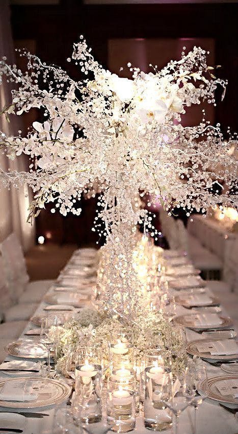 the babys breath makes it look whimsical I love it maybe not as high especially if outdoors---- Wedding ● Winter White Centerpiece Winter Wonderland Wedding Centerpieces, Winter Table Decorations, Tree Wedding Centerpieces, Winter Wedding Table, Winter Wedding Centerpieces, Snowflake Decoration, New Year's Eve Wedding, New Years Wedding, Winter Wonderland Decorations