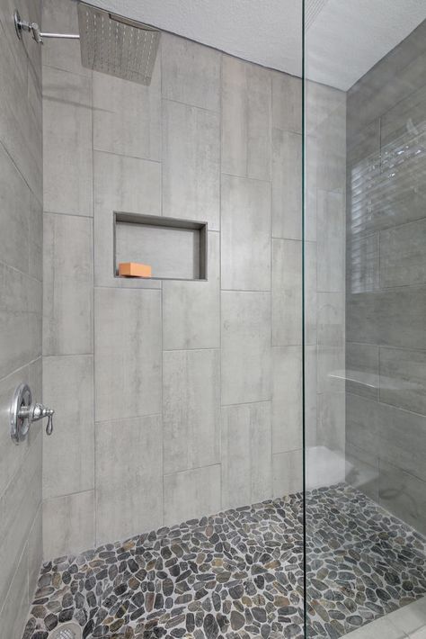 Walk-in Shower with Chrome Fixtures, and flat river rock shower floor Shower Floor Rock Tile, Grey River Rock Shower Floor, Walk In Shower With Stone Floor, Walk In Shower Designs Tile Modern, Shower With Pebble Floor River Rocks, Showers With River Rock Floors, Stone Floor Shower River Rocks, Tile Shower Floor Ideas Walk In, Stone Bottom Shower Pebble Floor