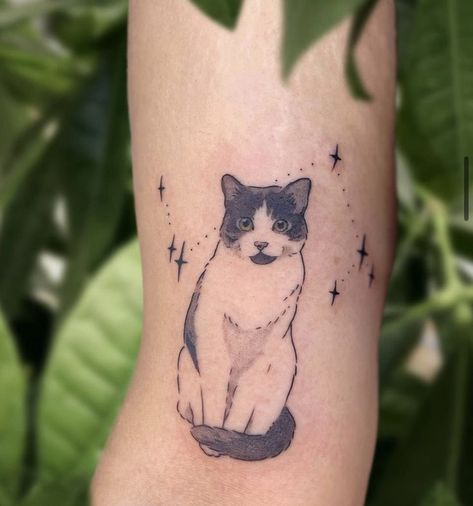 A minimalist cat tattoo can be a charming and subtle way to express your love for felines. Consider a simple outline of a cat's silhouette, perhaps with clean lines and minimal detail. You could opt for a small design on your wrist, ankle, or behind the ear for a discreet yet stylish look. Black ink tends to work well for minimalist tattoos, but you could also explore other subtle colors if you prefer. Just ensure you find a talented tattoo artist who specializes in minimalist designs White And Black Cat Tattoo, Cat Tattoo Tuxedo, Custom Cat Tattoo, Cat Tattoo Designs Memorial, Pet Tattoos Cat Memorial, Tortie Cat Tattoo, Cat Tattoo Portrait, Pet Cat Tattoo, Cute Black Cat Tattoo