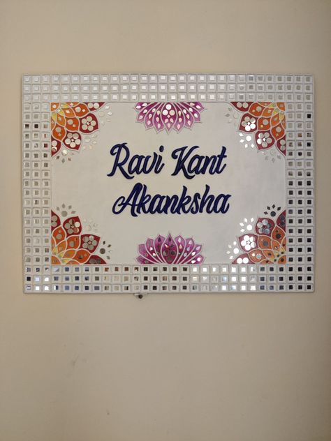 Motifs and mirrors are combined to make this beautiful customised handmade nameplate on 18"×24" board... Mirror Work On Mdf Board, Lippin Art Name Plate, Lippan Art Welcome Board, Name Plate Lippan Art Ideas, Lippan Art Mirror Name Plate, Handmade Nameplate Ideas, Lippan Art Nameplate, Mosaic Nameplate, Lipan Art Nameplate