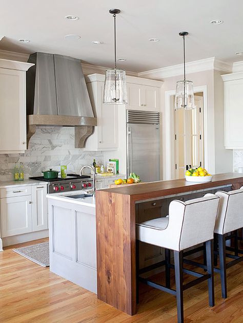 In need of extra dining space but not willing to give up valuable preparation area on the island? Place a tall bar table next to the island using complementary materials -- in this kitchen, that means a stained-wood countertop. An island extension such as this offers a place for eating meals and doing homework. Eat In Bar Kitchen, Eat In Island Kitchen, Kitchen Island Bar Ideas, Eat In Kitchen Island, Fun Kitchen Island, Kitchen Island Bar Height, Miami Townhouse, Island Extension, Hoboken Apartment