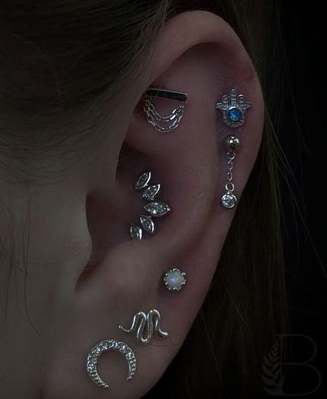 Junipurr Jewelry on Instagram: "How amazing is this white gold ear project from @botanical.piercer ?! 🌙 This curation features the following Junipurr ends Blue Hamsa -Helix Piercing Daphne -Helix Piercing Daria -Faux Rook Piercing Havana -Conch Piercing Crown-set with opal -Third Lobe Piercing Thank you so much for sharing with us! . . . . . . #curatedpiercing #piercings #piercing #piercer #canadianpiercing #piercingshop #piercingstudio #goldjewelry #piercingjewelry #bodyjewelry #piercer Piercing Curation, Ear Project, Minimalist Ear Piercings, Blue Hamsa, Ear Curation, Piercing Inspiration, Ear Art, Cool Ear Piercings, Pretty Ear Piercings