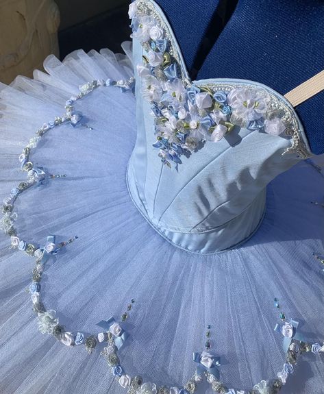 Beautiful blue flower tutu, traditional piped sweetheart bodice. Fully lined with blue and white ribbon roses, bows embellishing the bodice and metallic silver trim. The Tutu skirt has 9 full layers of alternating blue and white nets, with crystal tulle trim to give an extra depth of color with a flower overlay with more ribbon roses and crystals. Hook and eye closure. Custom Made. Delivery time: 5 to 7 weeks $1000 AUD plus postage Luxury Blue Tutu Dress With Ruffles, Luxury Blue Ruffled Tutu Dress, Luxury Blue Tutu Dress For Dress-up, Luxury Blue Princess Tutu Dress, Luxury Tulle Tutu Dress With Fitted Bodice, Luxury Tutu Dress With Fitted Bodice, Ballet Themed Dress, Light Blue Tutu Dress, Ballet Costumes Tutus Ballerina Tutu